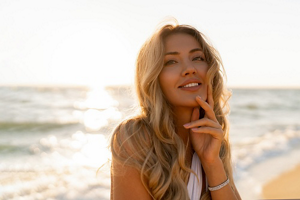 Young woman at the beach with long, loose blonde mermaid hair